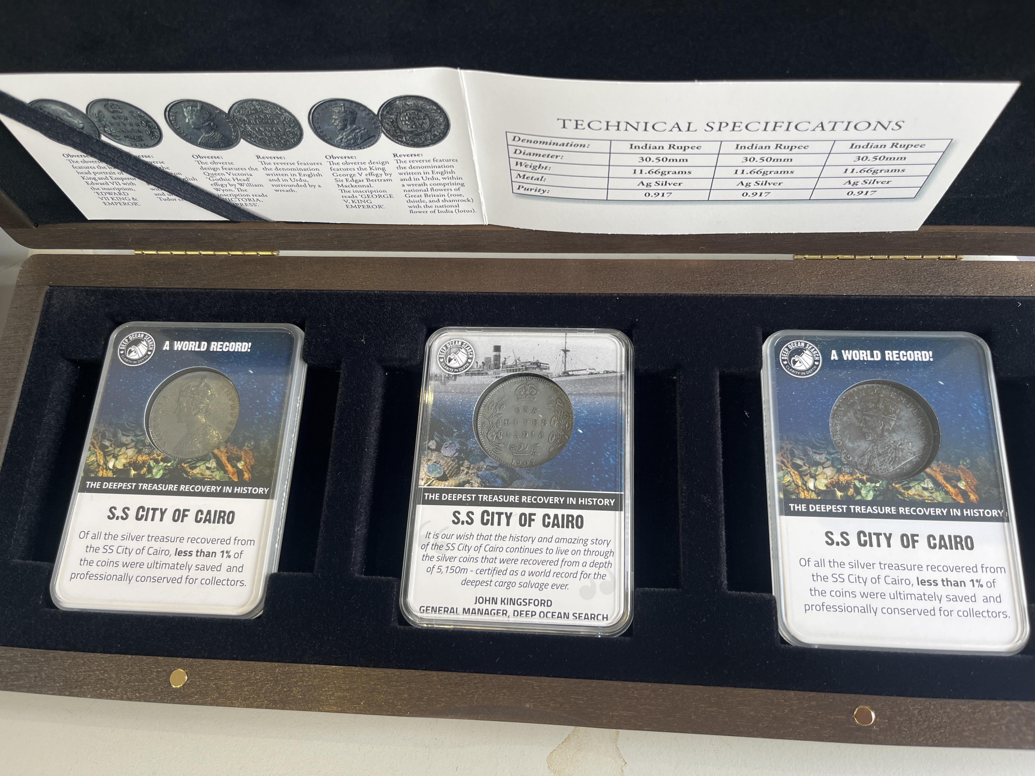 British India silver coins, three Victoria to George V one rupee, recovered form the wreck of S.S City of Cairo, 1879, 1907 and 1914, in London mint office case of issue with certificate